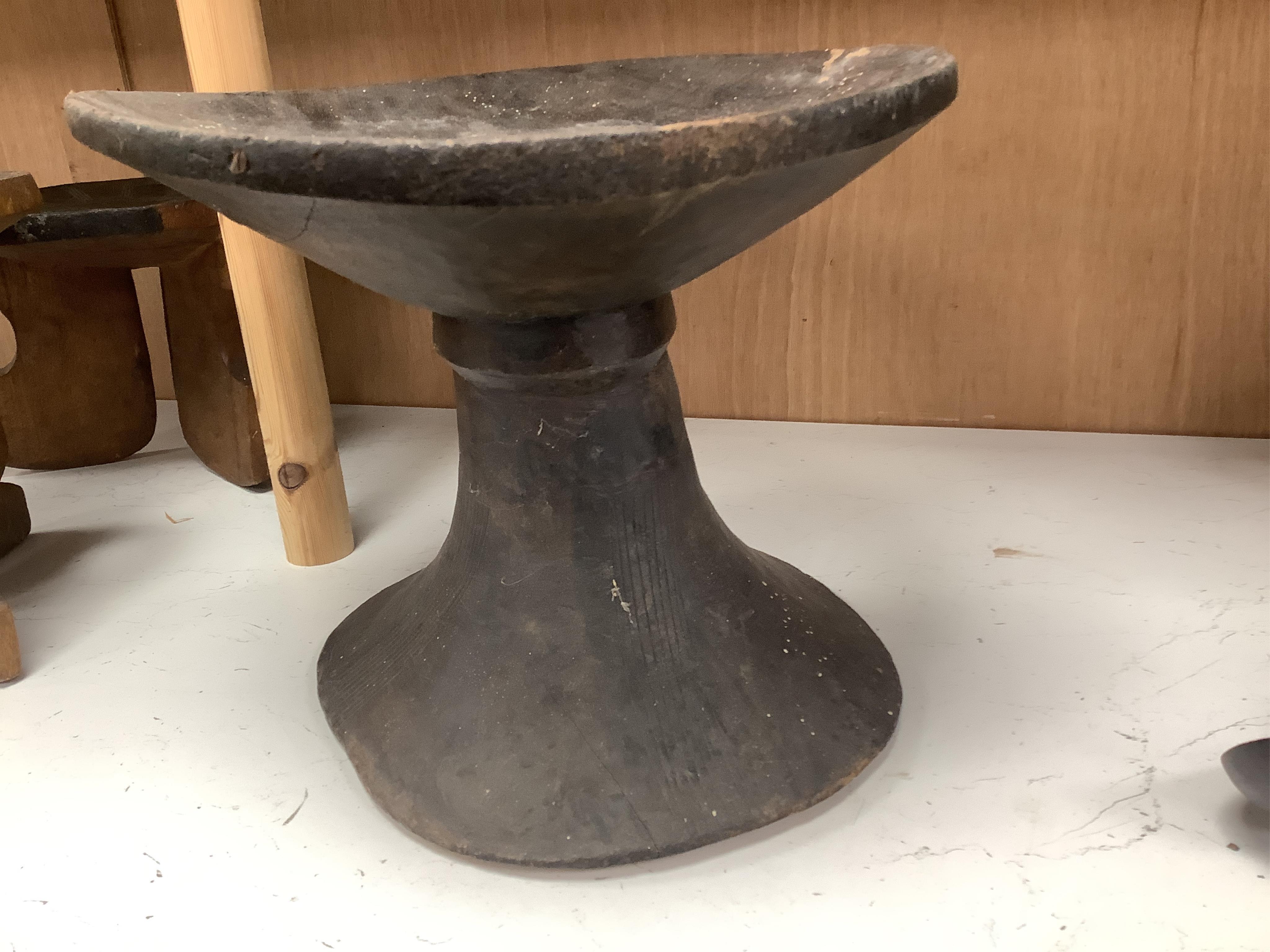Two African tribal busts, two carved spoons and three carved Kamba Kenyan stools (11). Largest stool 28cm high. Condition - mostly good, some staining to seat of largest stool
